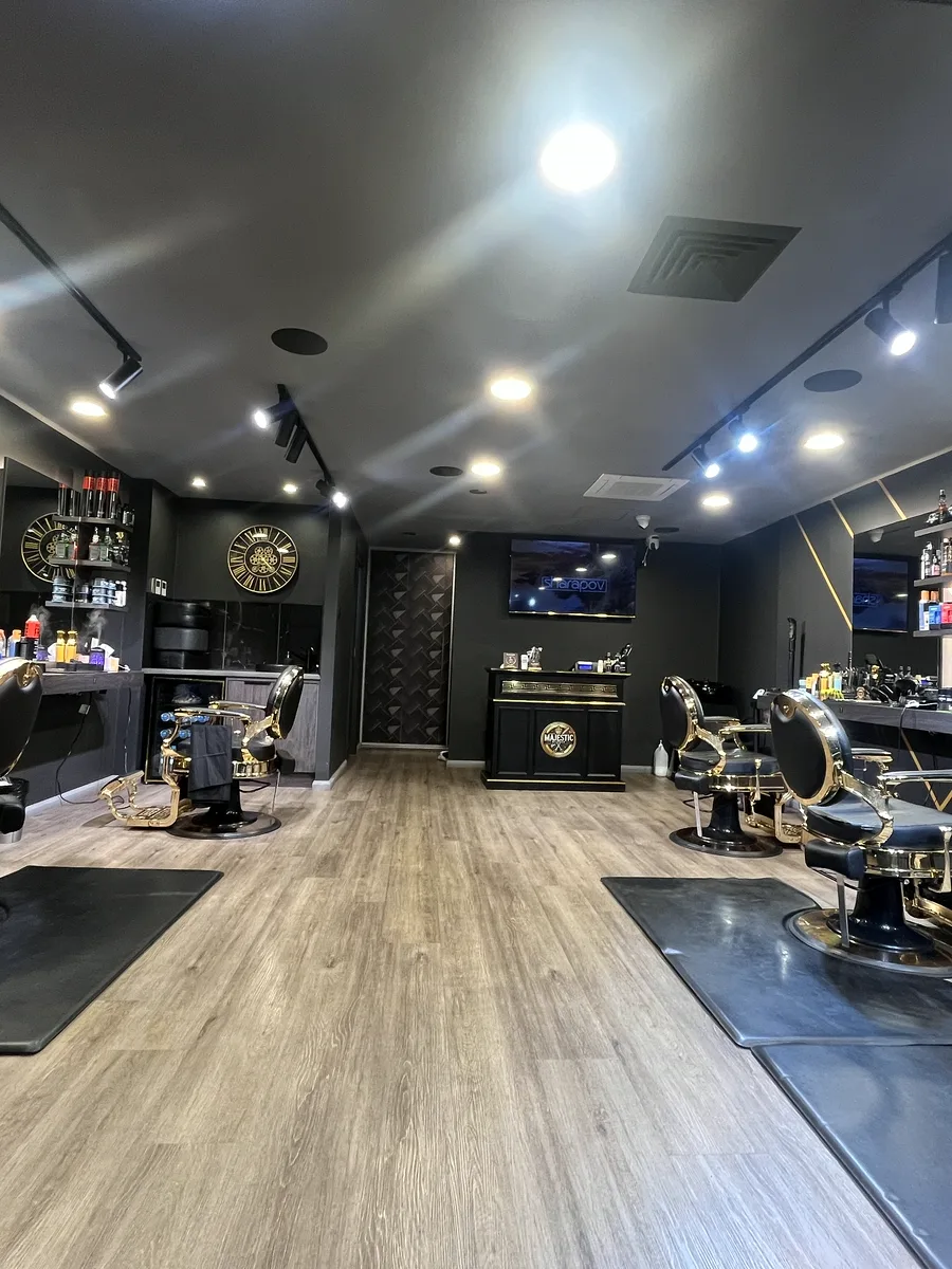 Inside Majestic Barber Menai — gold barber chairs and warm lighting
